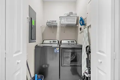 a small kitchen with a stove and a refrigerator at Amazing 05 Bedrooms At Storey Lake in Kissimmee