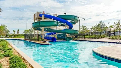 a water slide in a pool at a resort at Amazing 05 Bedrooms At Storey Lake in Kissimmee