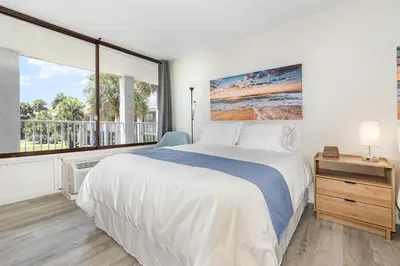 a bedroom with a large bed and a large window at 2050 E IRLO BRONSON 1BED in Kissimmee