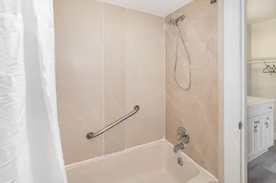a bathroom with a bath tub with a shower curtain at 2050 E IRLO BRONSON 1BED in Kissimmee