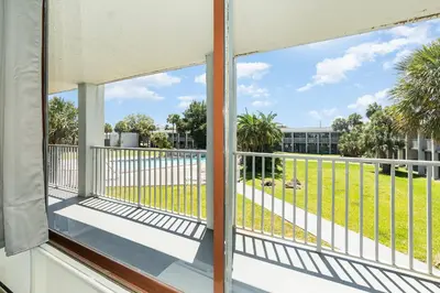 a balcony with a view of a park at 2050 E IRLO BRONSON 1BED in Kissimmee
