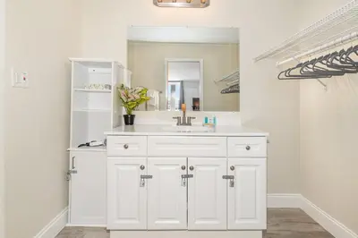 a white bathroom with a sink and a mirror at 2050 E IRLO BRONSON 1BED in Kissimmee