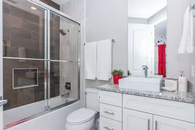 a bathroom with a toilet and a sink and a shower at Magic 5bd House 8 min from Disney in Orlando