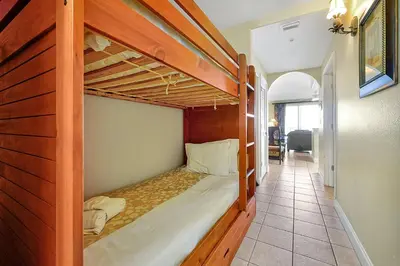 two bunk beds in a room with a hallway at Disney Dream Condo & Lake View Awaits in Orlando