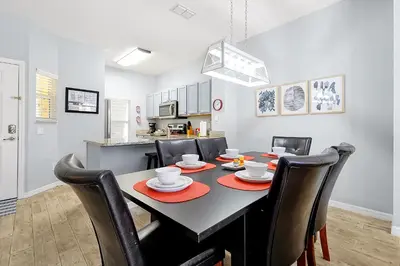 a dining room and kitchen with a table and chairs at 8567 BAY LILY LOOP 3 BED in Kissimmee