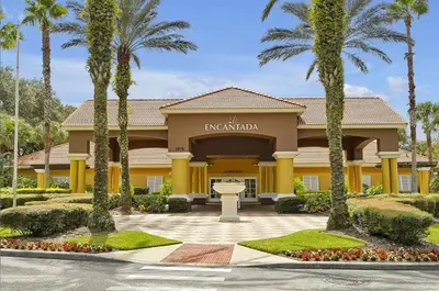 a hotel with palm trees in front of a building at 8567 BAY LILY LOOP 3 BED in Kissimmee