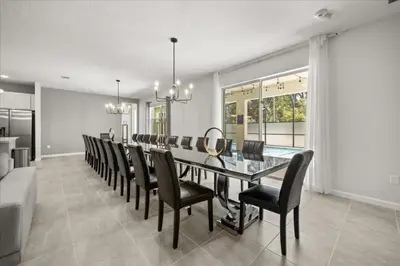a dining room with a long table and chairs at 15 Bedrooms15 Bathrooms Veranda Palms 2393Sd in Kissimmee