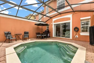 a swimming pool in a patio with a table and chairs at 3 Bedrooms 3 Bathrooms Encantada Resort 3097Yl in Kissimmee