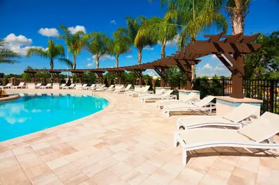 a row of lounge chairs next to a swimming pool at TVPM-3230WA in Kissimmee