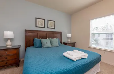 a bedroom with a blue bed with towels on it at TVPM-3230WA in Kissimmee