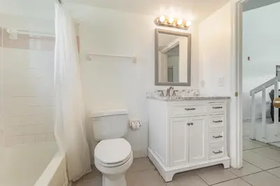 a bathroom with a toilet and a sink and a shower at 8702 PAPAYA DR 2BED in Kissimmee