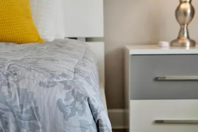 a bedroom with a bed with a dresser and a night stand at 1617 Retreat Circle Clermont 3 BED in Orlando