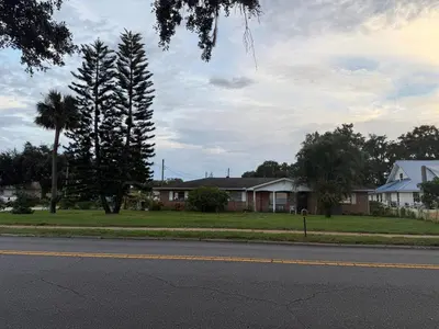 a house on the side of a road with a street at Family retreat with lake views and near Disney in Saint Cloud