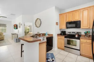 a kitchen with a sink and a stove top oven at 2888 OAKWATER KISSIMMEE 3BEDS in Orlando