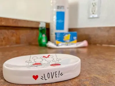 a white plate with the word love on it on a counter at 2888 OAKWATER KISSIMMEE 3BEDS in Orlando