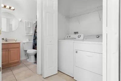 a white bathroom with a sink and a toilet at 2888 OAKWATER KISSIMMEE 3BEDS in Orlando
