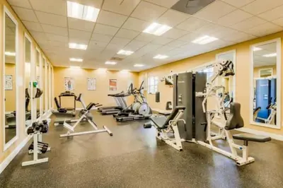 a gym with several treadmills and machines in a room at 2888 OAKWATER KISSIMMEE 3BEDS in Orlando