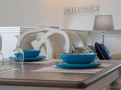 a table with two blue bowls on top of it at OAKWATER KISSIMMEE 3 BEDS in Orlando