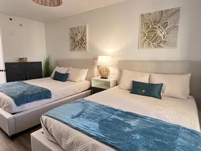 two beds in a small room with twoitures at Suite near Epic Universe & Universal, free parking in Orlando
