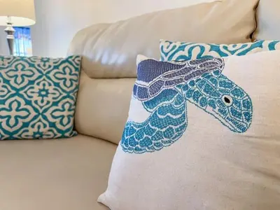 a pillow on a couch with a fish on it at 7742 WATER OAK KISSIMMIEE 4BED in Orlando