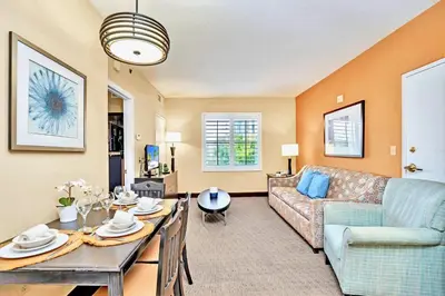a living room with a couch and a table at Peaceful 1 King BR Apartment w Hot Tub & Pool in Orlando