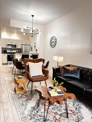 a living room with a couch and a table at Modern 3BR Retreat with Comfort & Style Near Disney in Kissimmee