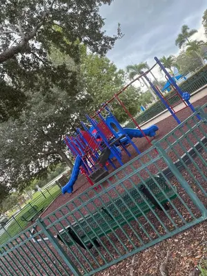 a blue and red playground in a park at Modern 3BR Retreat with Comfort & Style Near Disney in Kissimmee
