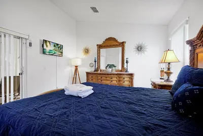 a bedroom with a blue bed with towels on it at 108 Stetson Court Kissimie in Kissimmee
