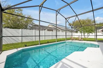 a swimming pool in a house with a glass enclosure at 108 Stetson Court Kissimie in Kissimmee