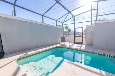 a swimming pool in a house with a glass roof at TVPM-5005WASL in Kissimmee