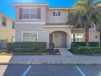a house with a palm tree in front of it at TVPM-5005WASL in Kissimmee