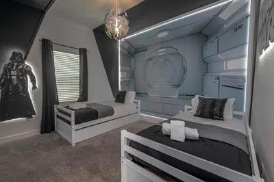 a bedroom with two beds and a captain america statue at TVPM-5005WASL in Kissimmee
