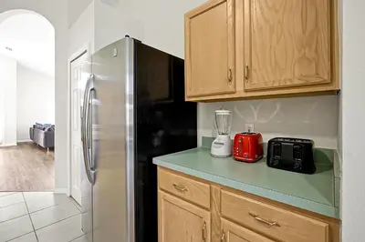 a kitchen with a refrigerator and a blender on a counter at 938 Lake Berkley Kissimmee FL 34746 in Kissimmee