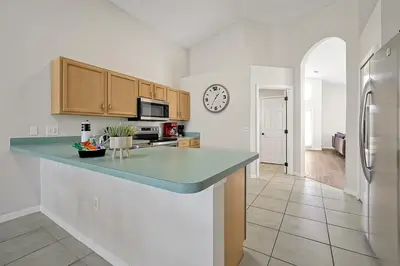 a kitchen with a counter and a clock on the wall at 938 Lake Berkley Kissimmee FL 34746 in Kissimmee