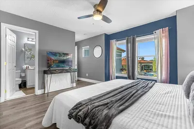 a bedroom with a white bed and a bathroom at TVPM-1191MBBV in Kissimmee