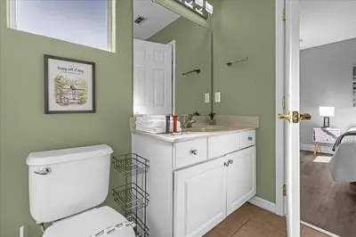 a bathroom with a toilet and a sink at TVPM-1191MBBV in Kissimmee