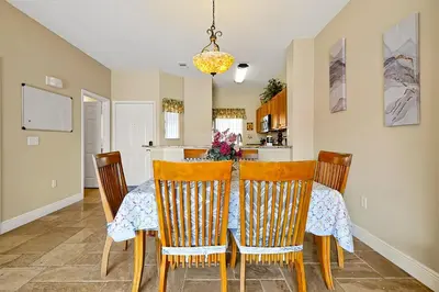 a kitchen and dining room with a table and chairs at 4703 Flagler Beach Way Kissimmee Florida 3BED in Kissimmee