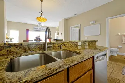 a kitchen with a stainless steel sink and granite counter top at 4703 Flagler Beach Way Kissimmee Florida 3BED in Kissimmee