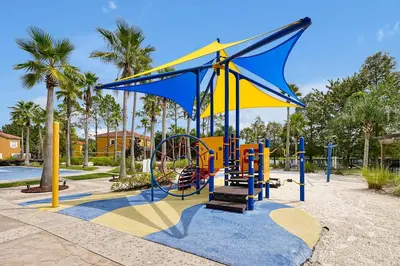 a playground in a park with a blue and yellow at 4703 Flagler Beach Way Kissimmee Florida 3BED in Kissimmee