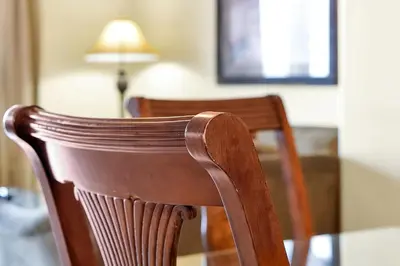 a wooden chair and a table with a lamp at 13415 BLUE HERRON BEACH DR in Orlando