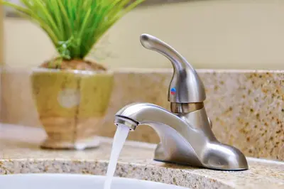 a sink with water coming out of a faucet at 13415 BLUE HERRON BEACH DR in Orlando