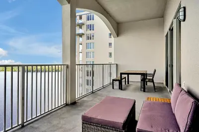 a balcony with a table and a couch and a table at 13415 BLUE HERRON BEACH DR in Orlando