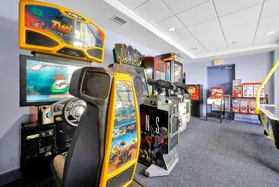 a room with arcade games and a video game system at 13427 BLUE HERRON TOWER 1 UNIT 707 ORLANDO 1 BED in Orlando
