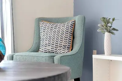 a blue chair with a pillow in a living room at 3161 PARADOX CIRCLE UNIT 406 KISSIMMEE 2 BEDS in Kissimmee
