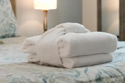 a pile of towels sitting on top of a bed at 3161 PARADOX CIRCLE UNIT 406 KISSIMMEE 2 BEDS in Kissimmee