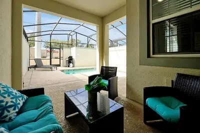 a living room with a couch and a table at 5017 WINDERMERE 4BED in Kissimmee