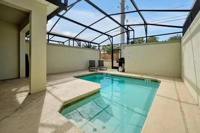 an indoor swimming pool with a glass roof at 5017 WINDERMERE 4BED in Kissimmee