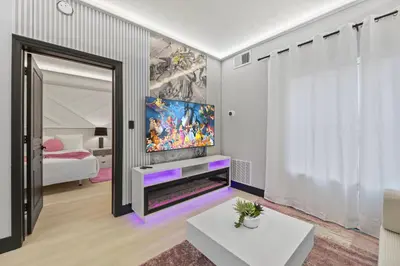 a living room with a tv and a large mirror at Prime Location 1BR Apt Near Epic OCCC in Orlando