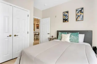 a bedroom with a large white bed with blue pillows at Big Condo 3 bedrooms, Pool in Kissimmee