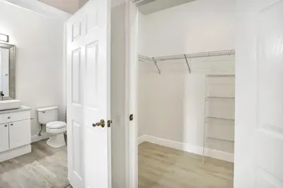 a white bathroom with a toilet and a sink at Big Condo 3 bedrooms, Pool in Kissimmee